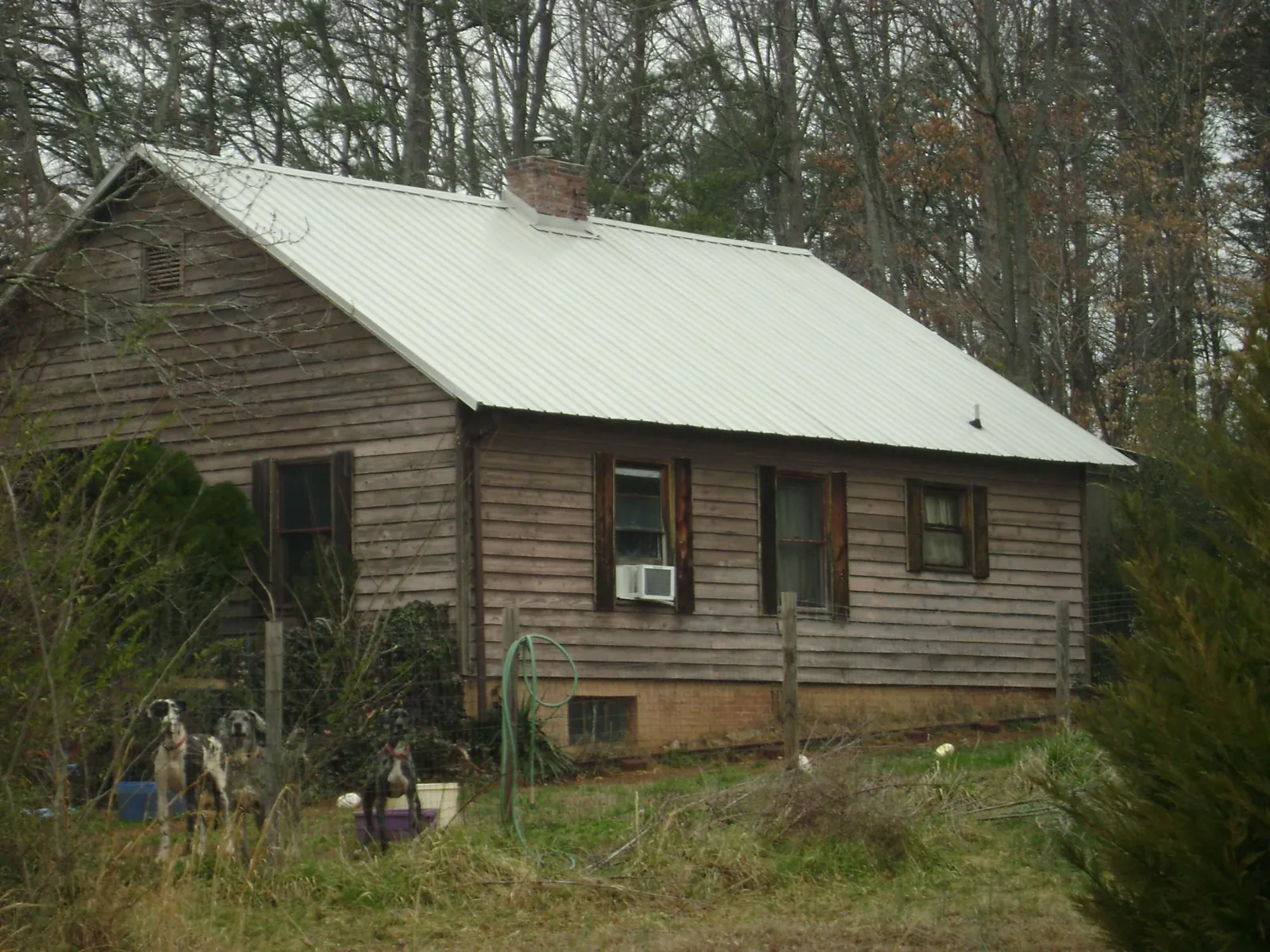 White metal roof on an old wood sided farmhouse, from a Metal Roof Installation job in New Bedford